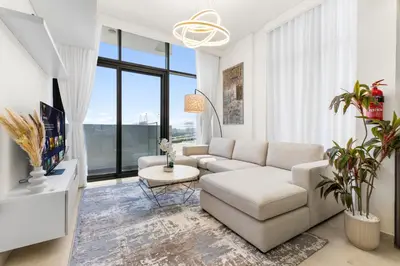 a living room with a couch and a table at Urban Chic Apartments in Dubai