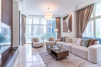 a living room with a couch and a table at The Smart Concierge - Marinascape Avant in Dubai