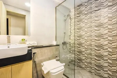 a bathroom with a toilet and a sink and a shower at Spacious 3BR Family Stay with Balcony Views of Burj and City Lights in Dubai