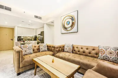 a living room with a couch and a table at Spacious 3BR Family Stay with Balcony Views of Burj and City Lights in Dubai