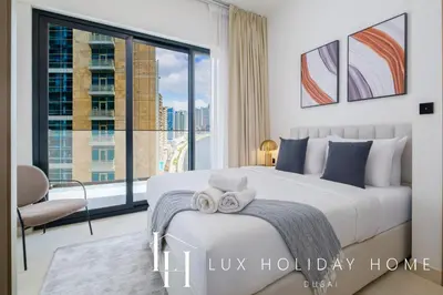 a bedroom with a bed and a large window at LUX The Modern Binghatti Canal Suite 3 in Dubai