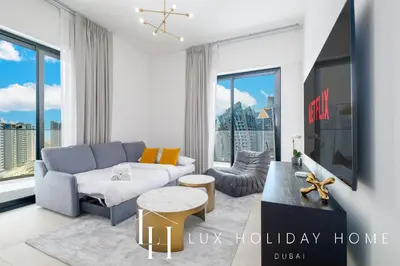 a living room with a couch and a tv at LUX The Modern Binghatti Canal Suite 3 in Dubai