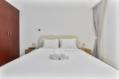 a bed with two pairs of shoes sitting on it at Chic 2-bed Oasis with Marina Views Walk to Beach! in Dubai