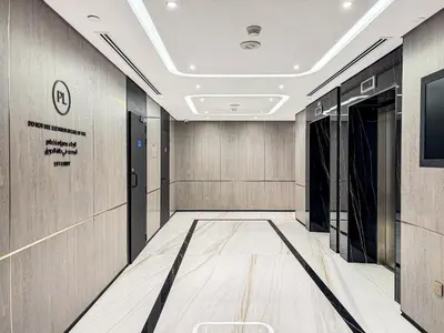 a hallway of a building with a sign on the wall at Chic 2-bed Oasis with Marina Views Walk to Beach! in Dubai