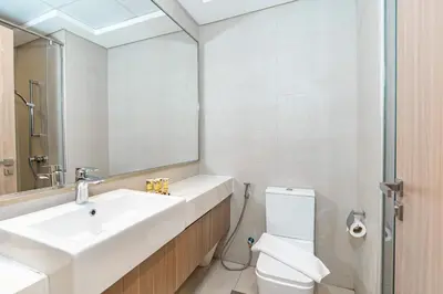 a bathroom with a sink and a toilet and a mirror at PVH - Azizi Riviera - Lovely Studio near Downtown in Dubai