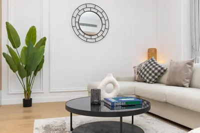 a living room with a couch and a table at Premium Apartment mit Strandzugang in Dubai in Dubai