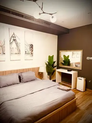 a bedroom with a large bed and a desk at Luxury Modern Apt in JBR 2 MIN to BEACH in Dubai