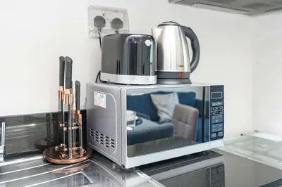 a microwave with a coffee pot on top of it at PVH - Golf Vita - 1BR with Golf Course View in Dubai