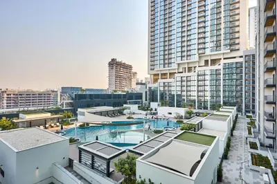 an aerial view of a pool in a city with tall buildings at STAY BY LATINEM Luxury 1BR Holiday Home CA 0906 Near Burj Khalifa in Dubai