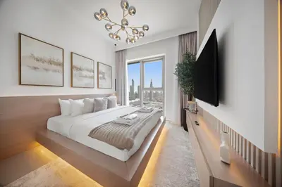 a bedroom with a large bed and a chandelier at Serene 2BR Burj View DT Dubai in Dubai