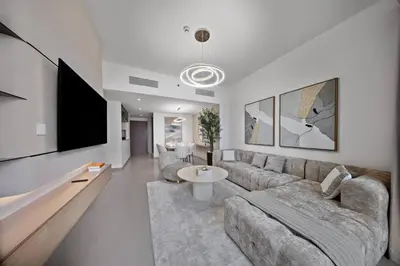 a living room with a couch and a flat screen tv at Serene 2BR Burj View DT Dubai in Dubai