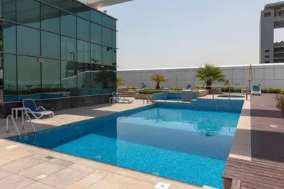 a large swimming pool in front of a building at The Minimalist JLT Studio in Dubai