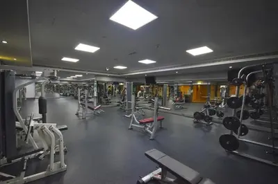 a gym with a lot of equipment in a room at The Minimalist JLT Studio in Dubai