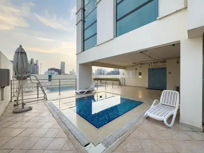 a balcony with a swimming pool on a building at GuestReady - Canal View Stay in Business Bay in Dubai