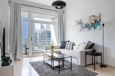 a living room with a white couch and a glass table at GuestReady - Canal View Stay in Business Bay in Dubai