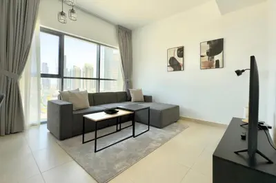 a living room with a couch and a table at 1 Bedroom Apt with Stunning Burj Khalifa View in Dubai