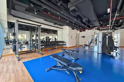 a gym with several treadmills and exercise machines at 1 Bedroom Apt with Stunning Burj Khalifa View in Dubai
