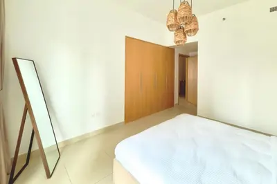 a bedroom with a bed and a wooden door at 1 Bedroom Apt with Stunning Burj Khalifa View in Dubai