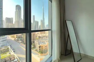 a view of a city skyline from a window at 1 Bedroom Apt with Stunning Burj Khalifa View in Dubai