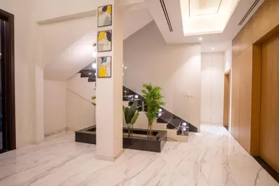 a hallway of a building with stairs and plants at Luxury 5 Bedroom Villa Nad Al Sheba in Dubai
