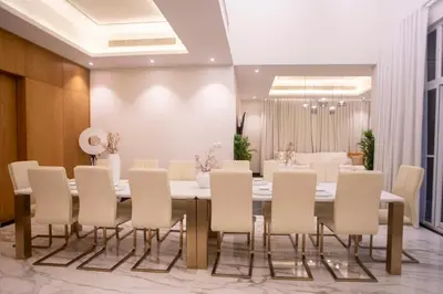 a dining room with a table and chairs at Luxury 5 Bedroom Villa Nad Al Sheba in Dubai