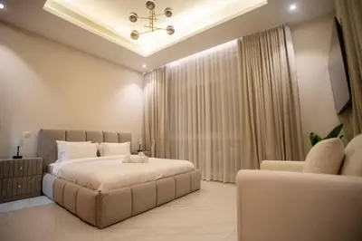 a bedroom with a large bed and a couch at Luxury 5 Bedroom Villa Nad Al Sheba in Dubai