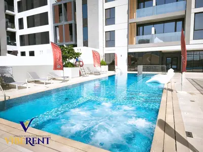 a swimming pool in the middle of a building at Explore Dubai from Aura - 2BHK in Dubai