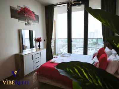 a bedroom with a bed and a large window at Explore Dubai from Aura - 2BHK in Dubai