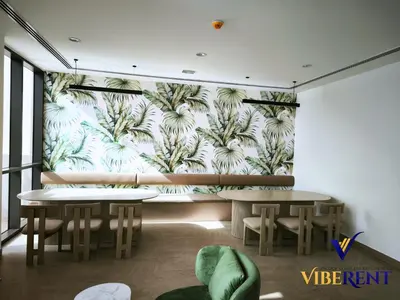 a restaurant with two tables and a mural of palm trees at Explore Dubai from Aura - 2BHK in Dubai