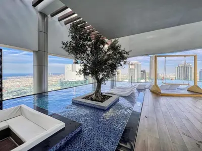a room with a tree on the floor of a building at Luxe 3BR in Paramount with Ocean View & Infinity Pool in Dubai
