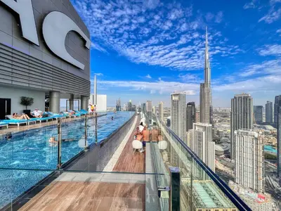 a pool on the top of a building with a view of the city at Luxe 3BR in Paramount with Ocean View & Infinity Pool in Dubai