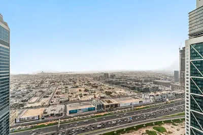 an aerial view of a city with traffic and buildings at Luxe 3BR in Paramount with Ocean View & Infinity Pool in Dubai