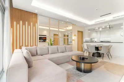 a living room with a couch and a table at Luxe 3BR in Paramount with Ocean View & Infinity Pool in Dubai