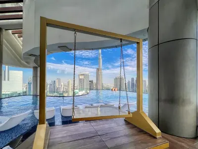 a swing in a room with a view of the city at Luxe 3BR in Paramount with Ocean View & Infinity Pool in Dubai