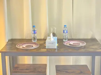 a table with plates and bottles of water on it at Chic studio in Central Dubai in Dubai