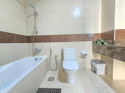 a bathroom with a toilet and a bath tub at Chic studio in Central Dubai in Dubai