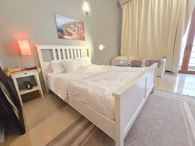 a bedroom with a large white bed in a room at Airy and Bright Near DIFC and the Subway in Dubai