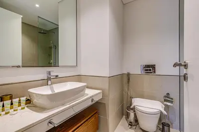 a bathroom with a sink and a toilet at Elegant 2 Bedroom Apartment - Jadeel 2, Madinat Jumeirah - Allsopp & Allsopp in Dubai