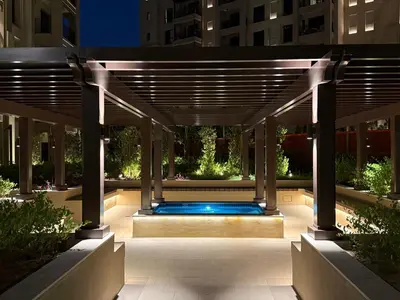 a swimming pool under a pergola at night at Elegant 2 Bedroom Apartment - Jadeel 2, Madinat Jumeirah - Allsopp & Allsopp in Dubai