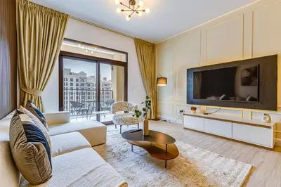 a living room with a couch and a tv at Elegant 2 Bedroom Apartment - Jadeel 2, Madinat Jumeirah - Allsopp & Allsopp in Dubai