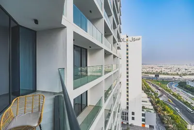 a balcony with a chair on a building at Escape24 Brand New 1BR with City View near Burj Khalifa in Dubai