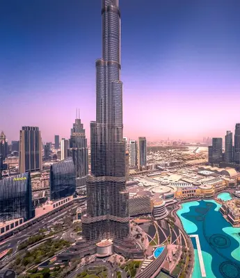 a view of a city with a tall skyscraper at GRANDE RESIDENCES with a direct Burj Khalifa view and Private Fountain Show at 62nd floor with DXB AIRPORT VIP Shuttle option for 8 guests in Dubai