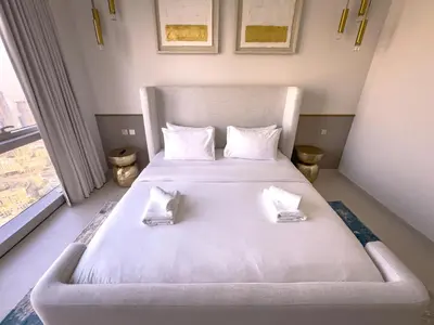 a bedroom with a bed with two pillows on it at GRANDE RESIDENCES with a direct Burj Khalifa view and Private Fountain Show at 62nd floor with DXB AIRPORT VIP Shuttle option for 8 guests in Dubai