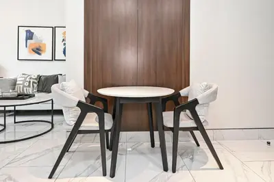 a dining room with a table and two chairs at Unwind in a Stylish Studio with Pool, Sauna, and Stunning City Views in Dubai