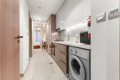 a laundry room with a washer and dryer at Cozy Luxe Studios in Meydan in Dubai