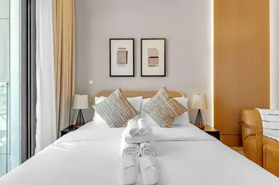 a bedroom with a bed with a stuffed animal on it at Cozy Luxe Studios in Meydan in Dubai