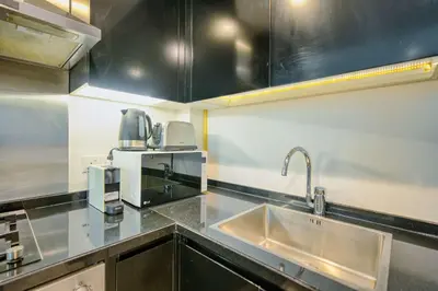 a kitchen with a sink and a coffee maker at PVH - Refined 1BR in Business Bay - Cour Jardin in Dubai