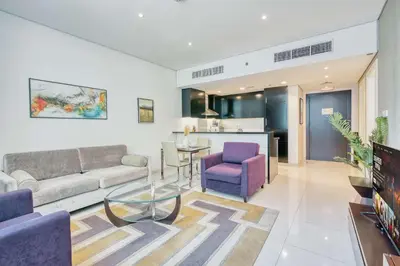 a living room with a couch and a table at PVH - Refined 1BR in Business Bay - Cour Jardin in Dubai