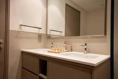 a bathroom with a white sink and a mirror at TRPS - Grande, Downtown - Full Burj Khalifa View, Luxury Furnished - Close to Dubai Mall in Dubai