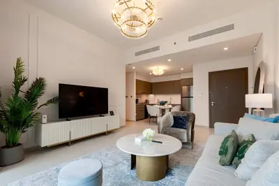 a living room with a couch and a tv at TRPS - Grande, Downtown - Full Burj Khalifa View, Luxury Furnished - Close to Dubai Mall in Dubai